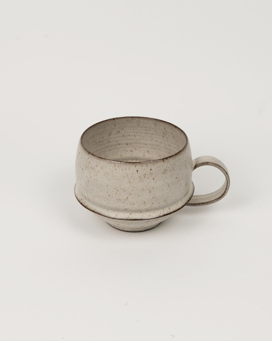 Beige ceramic cup on a light beige background