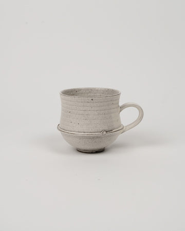 Stone Mist pinched rim coffee mug with footed base and loop handle
