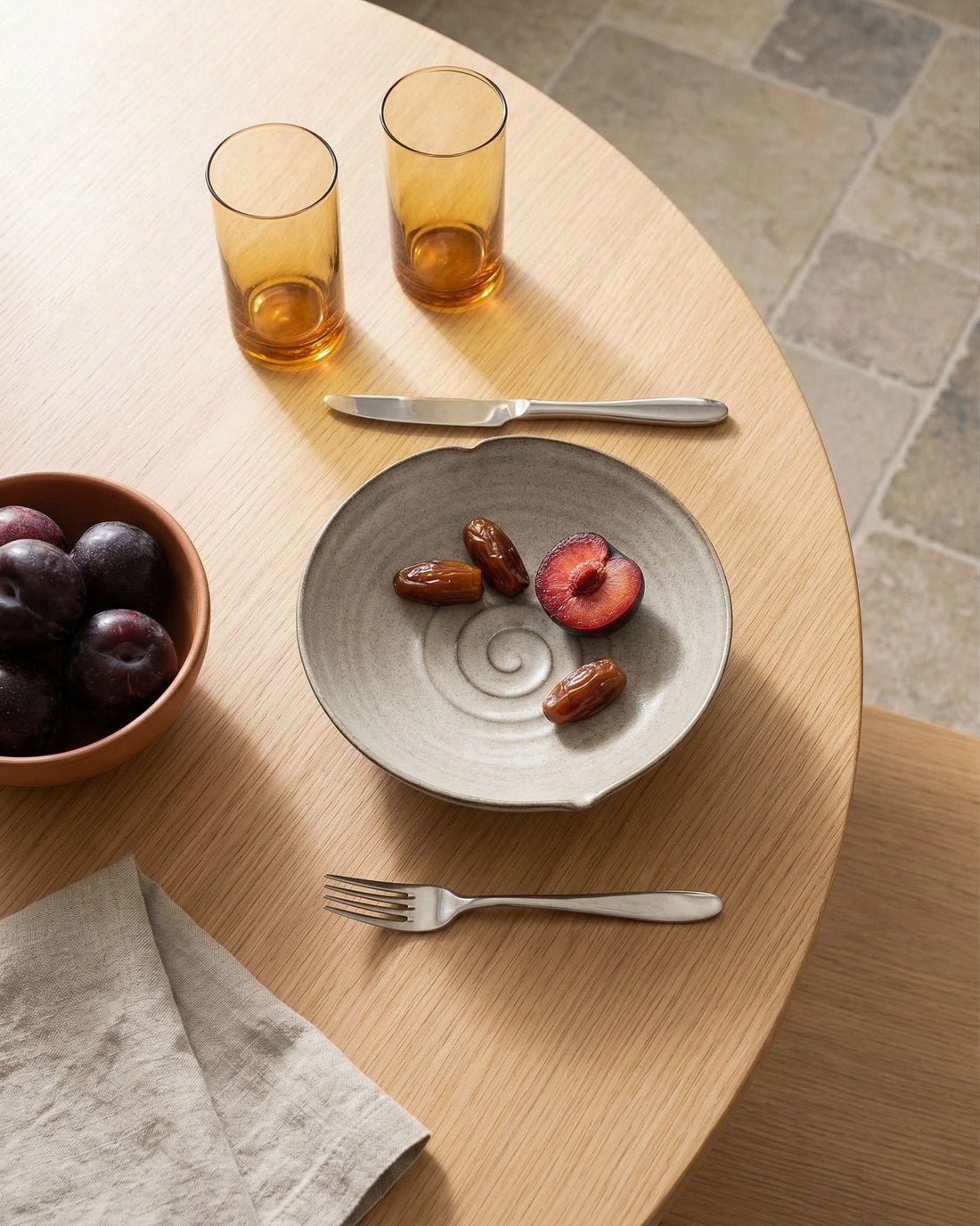 Beige ceramic bowl with a spiral design on a light beige background