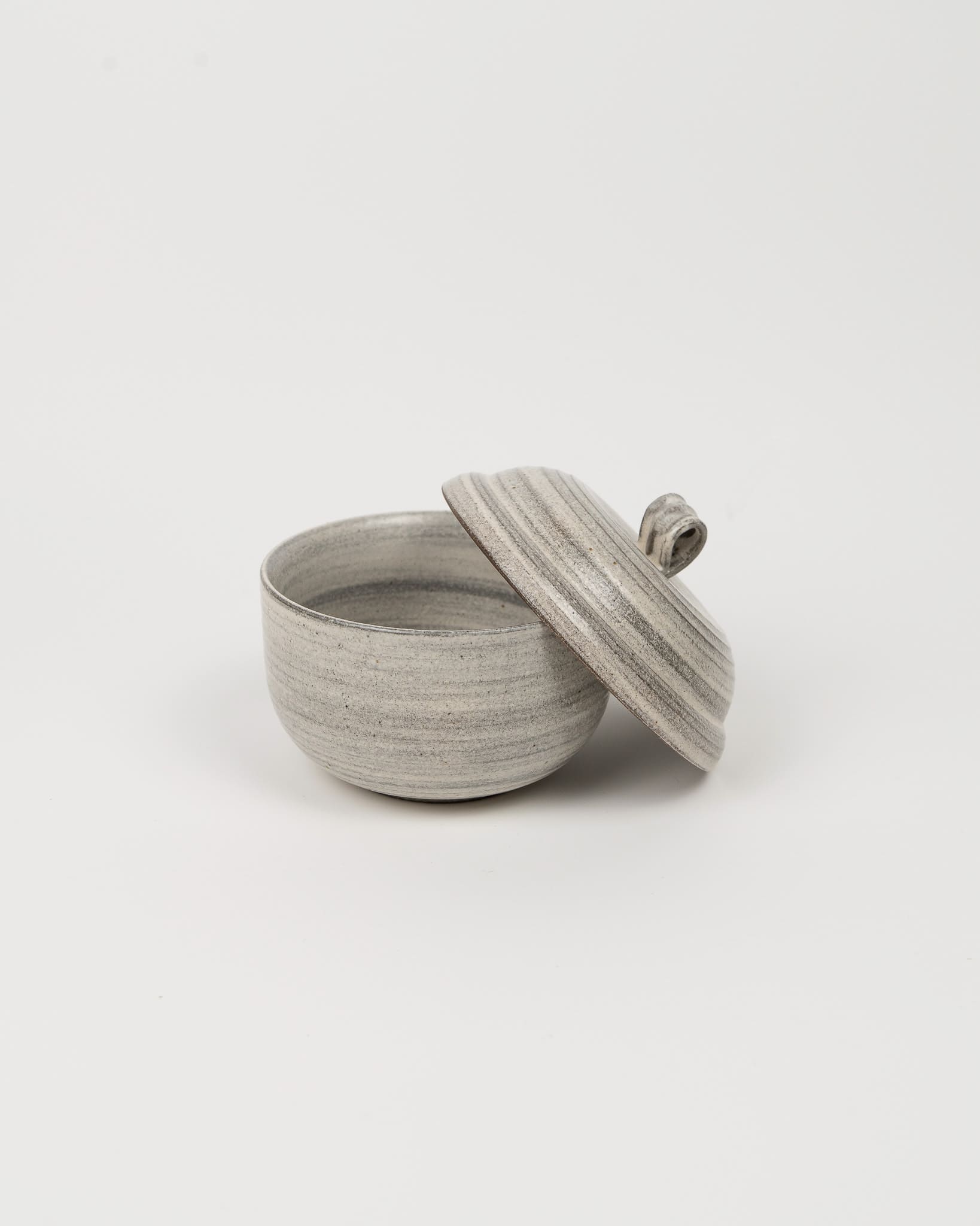 Gray ceramic bowl with lid on a white background