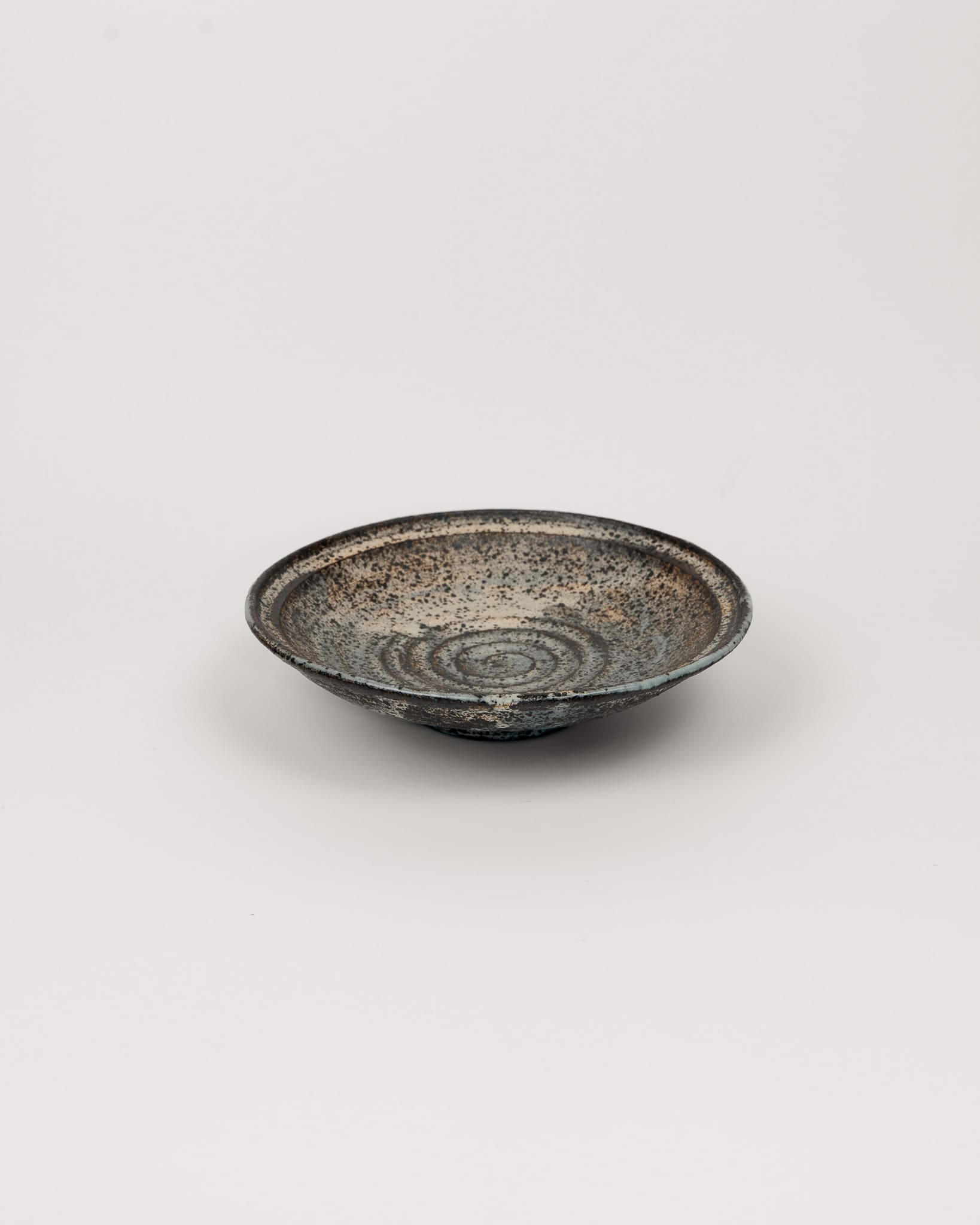 Ceramic bowl with textured surface on a light gray background
