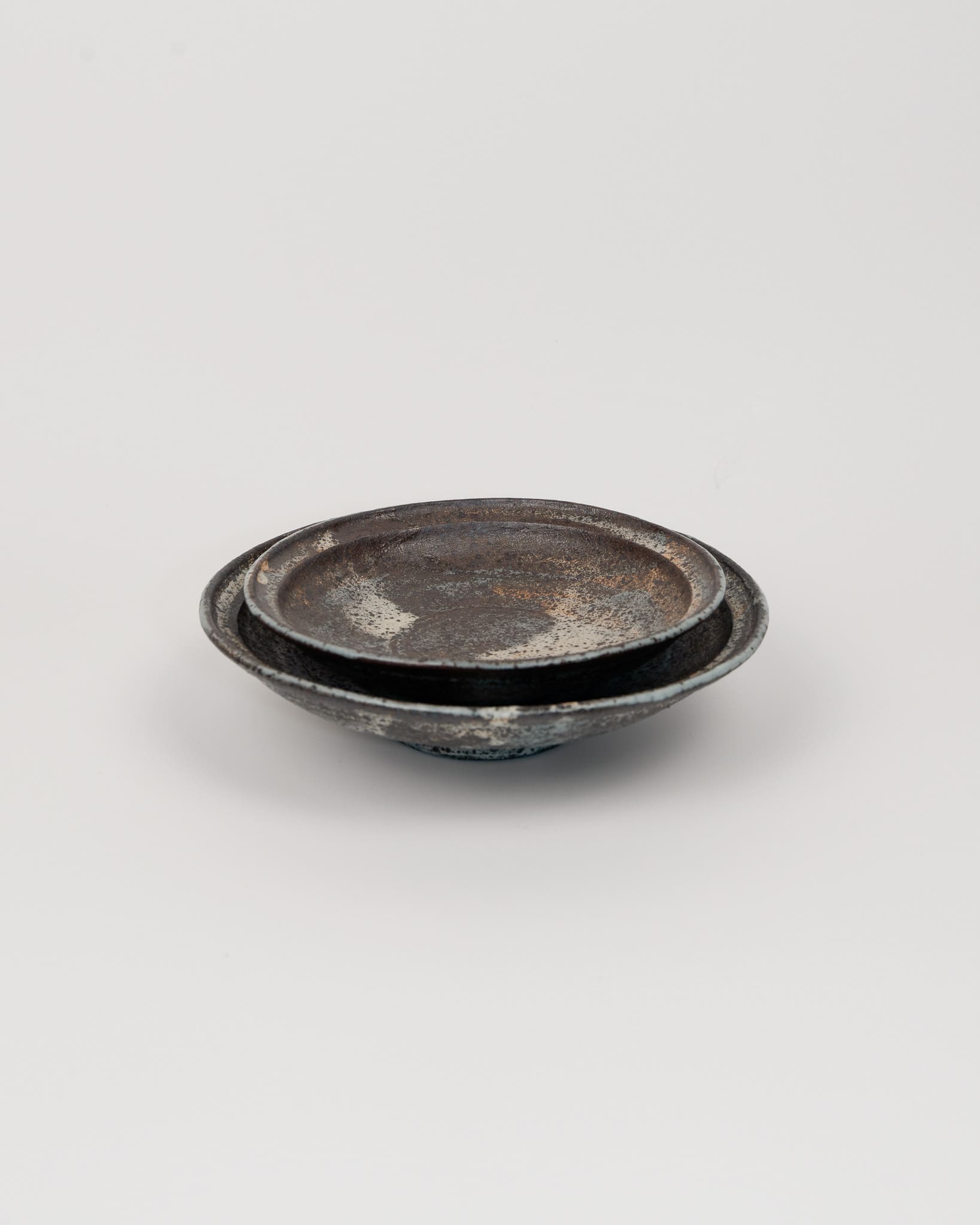 Two metallic bowls on a light gray background