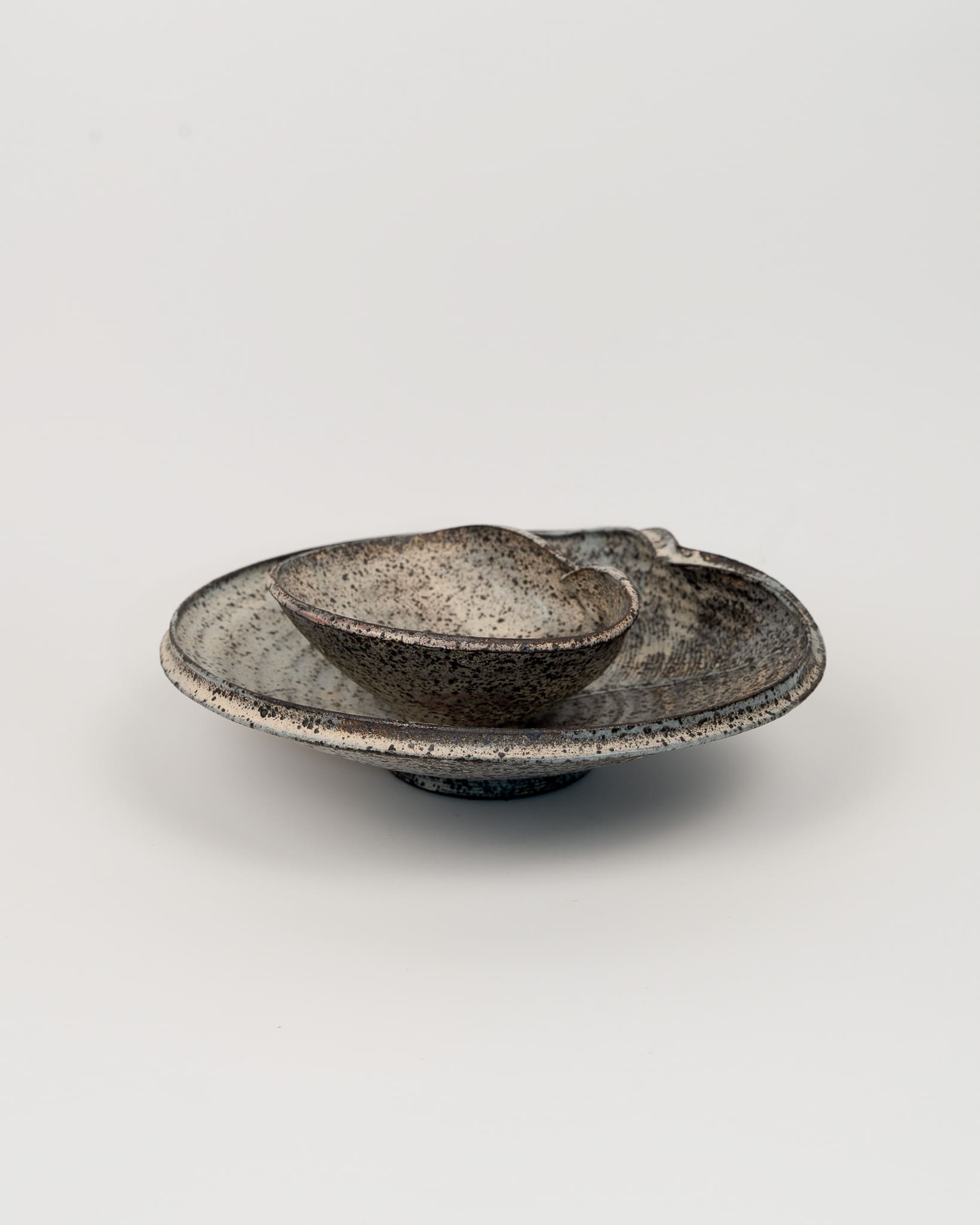Speckled ceramic bowl on a white background