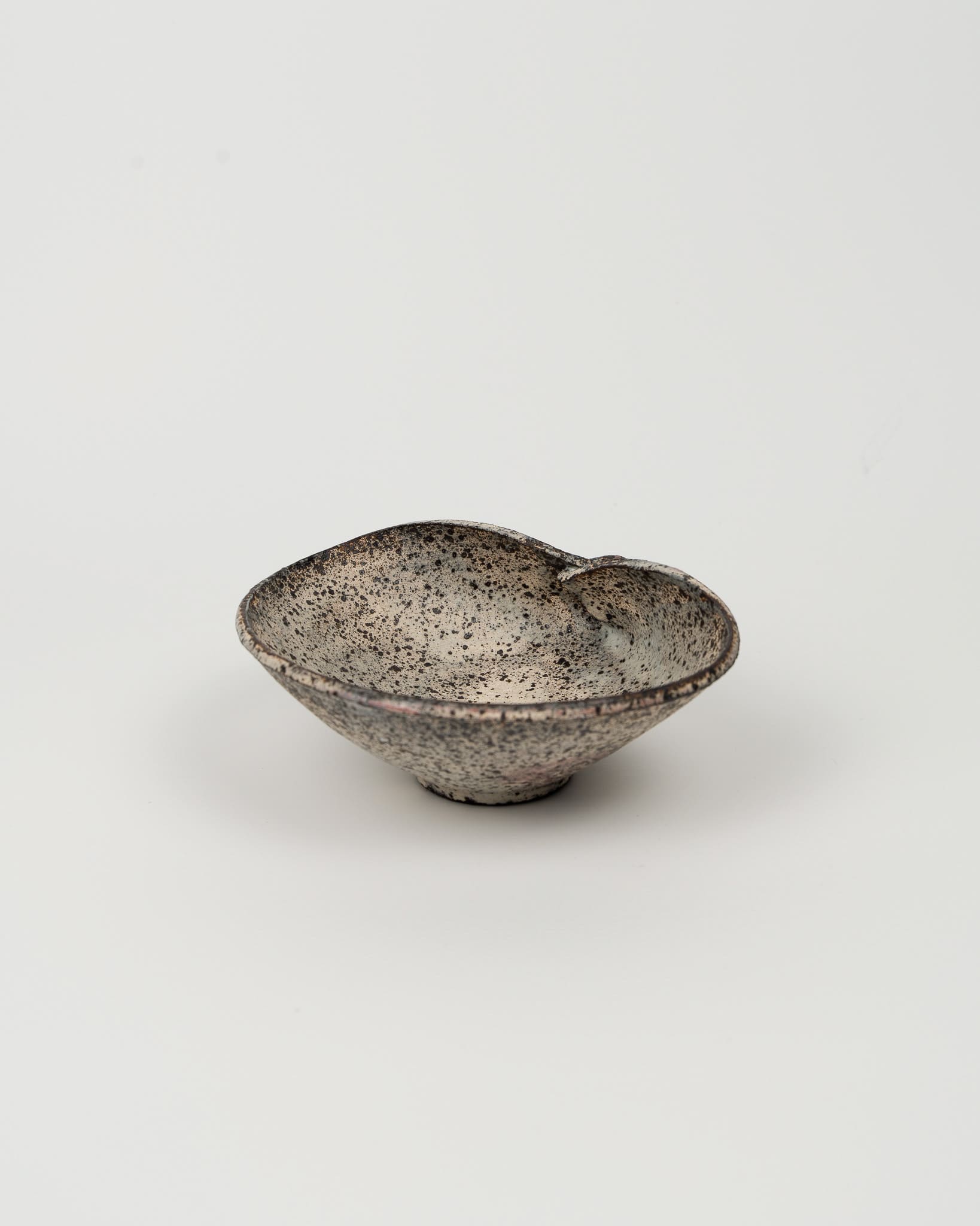 Speckled ceramic bowl on a white background